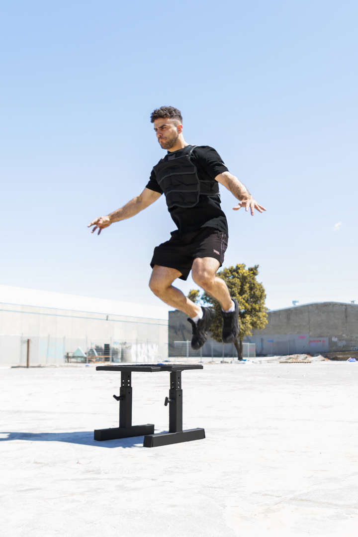 man doing box jump onto squat box